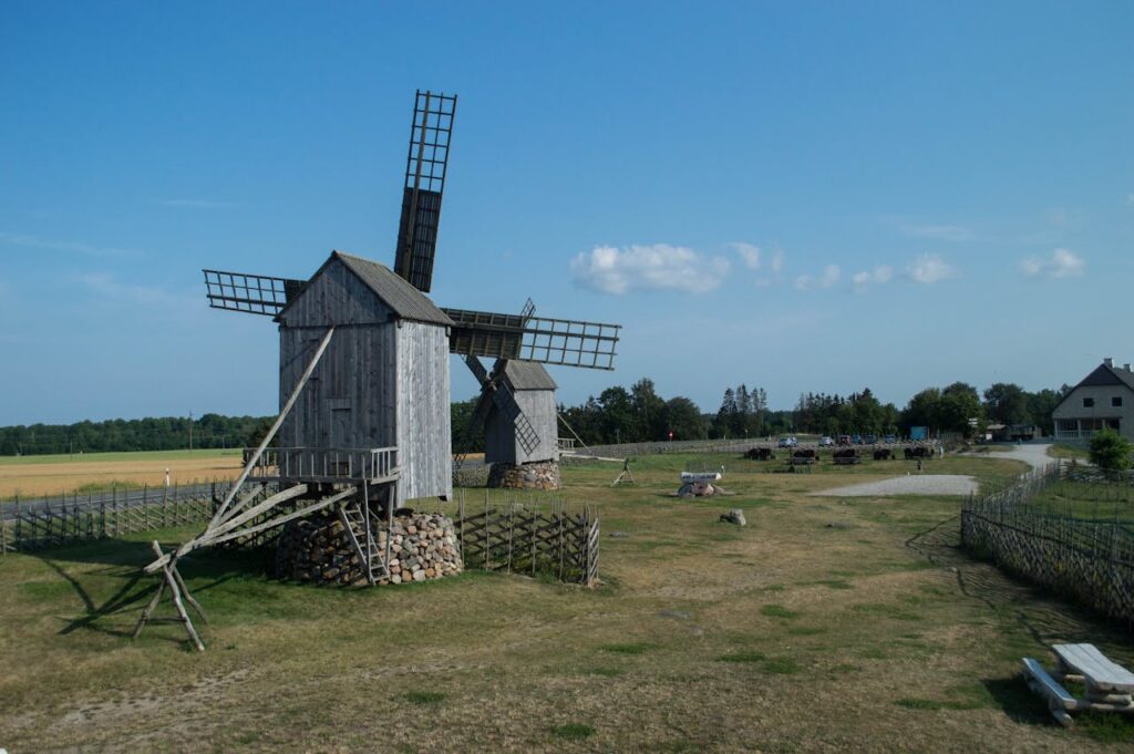pexels photo 18020726 Historic wooden windmills in rural Saaremaa, showcasing European rustic architecture.